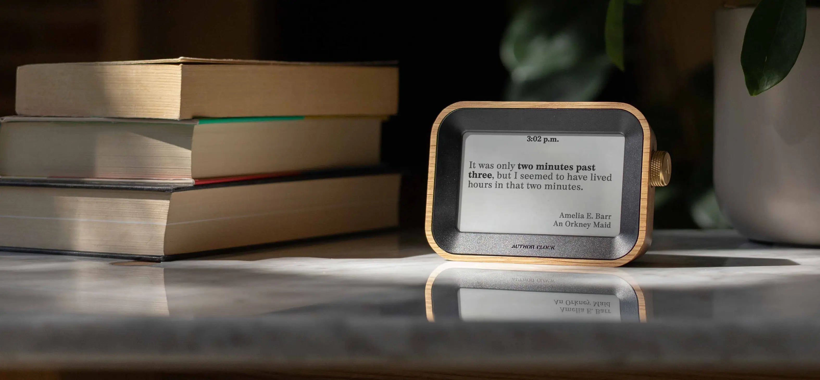 Author Clock on a marble table angled in bright sunshine