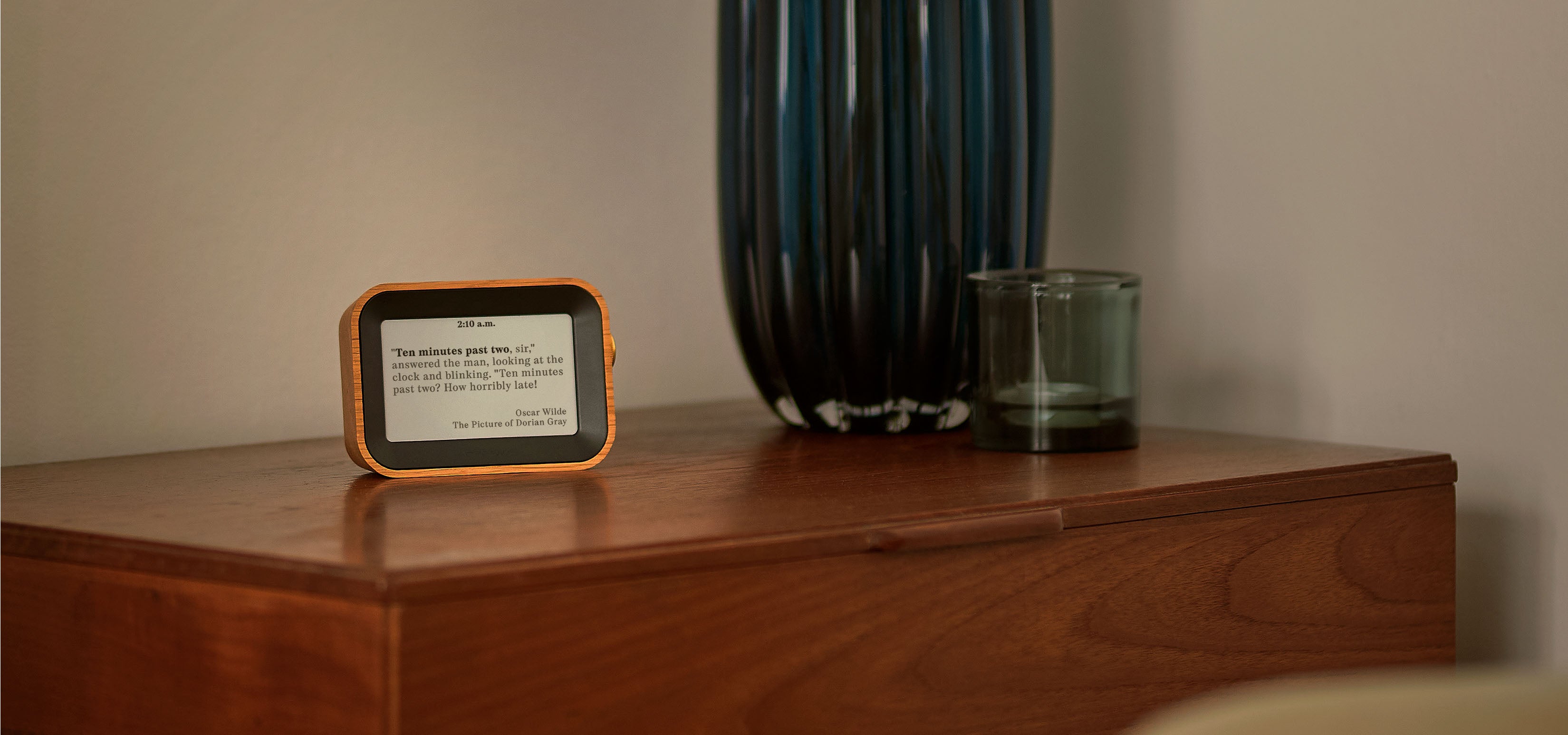 Author Clock Vol 1 on a wooden table displaying a quote by Oscar Wilde