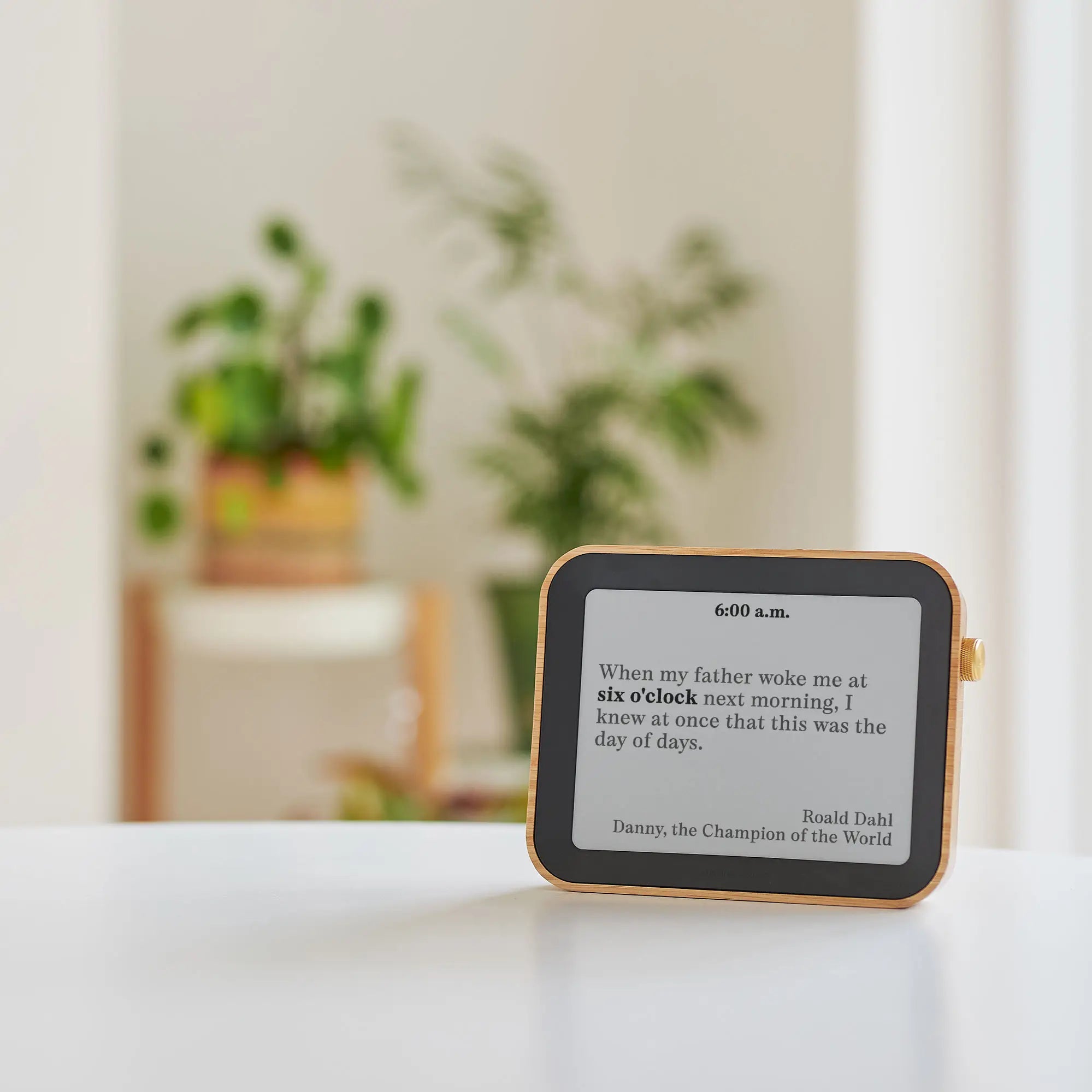 Author Clock Vol 2 Large on a white table in morning light, displaying a 6:00 a.m. quote from Roald Dahl’s Danny, the Champion of the World.